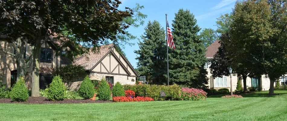 Manicured lawn with plants and a flag in Elm Grove, WI.