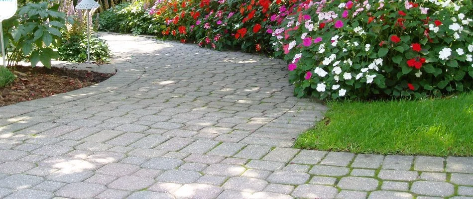 A paver walkway with colorful flowers in Brookfield, WI.